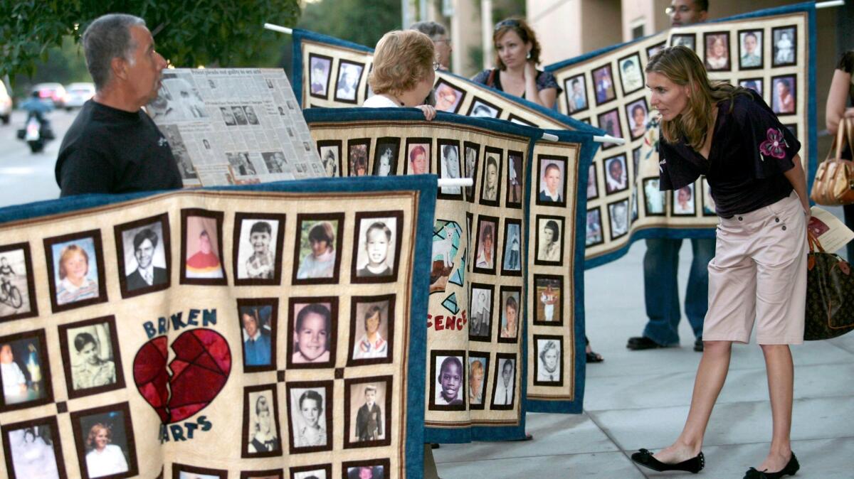 Photos of alleged victims of sexual abuse by Catholic priests, during a protest by the Survivors Network of those Abused by Priests in Los Angeles on Sept. 27, 2006.