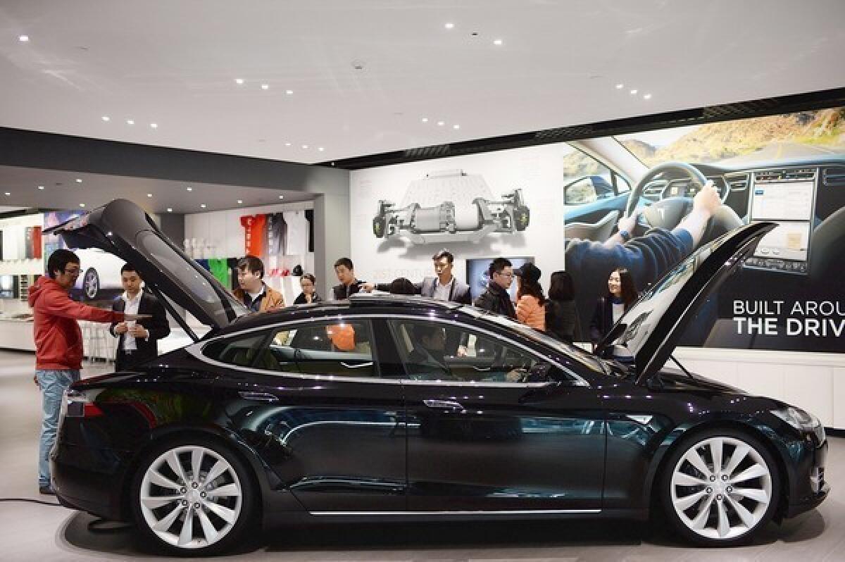 Tesla Motors has opened a showroom in Sydney and begun deliveries in Australia of its popular Model S electric car, like this one seen in a Beijing showroom.