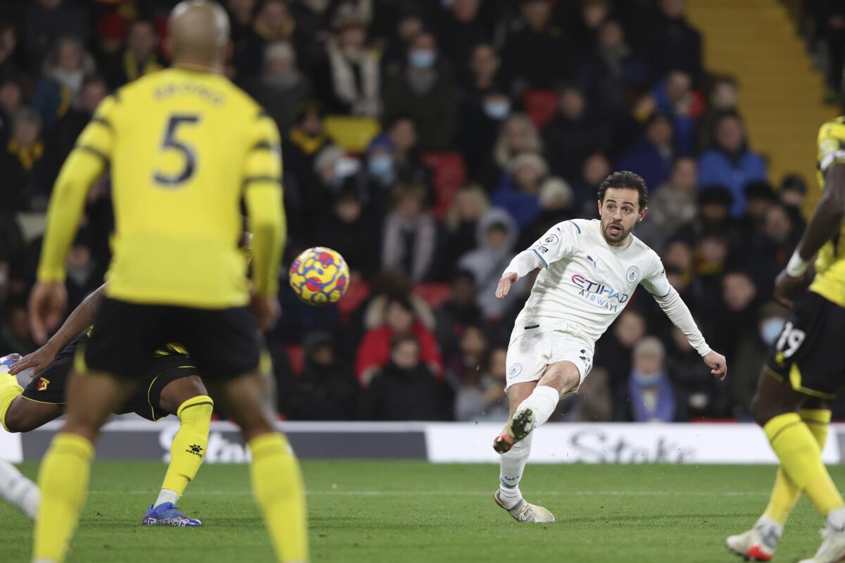 Manchester City's Bernardo Silva scores his side's third goal during the English Premier League soccer match between Watford and Manchester City at the Vicarage Road Stadium in Watford, England, Saturday, Dec. 4, 2021.(AP Photo/Ian Walton)