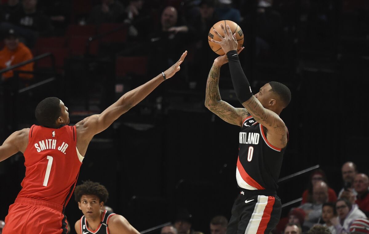 Portland Trail Blazers guard Damian Lillard, right, shoots over Houston Rockets forward Jabari Smith Jr.