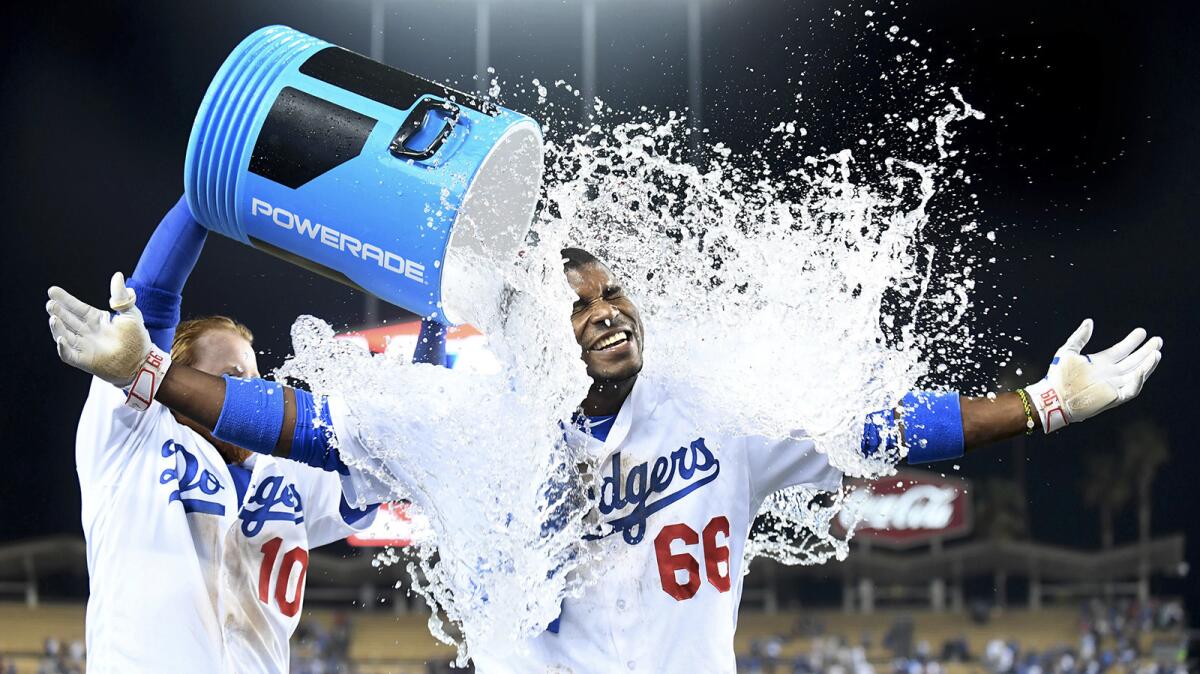Dodgers' Yasiel Puig celebrates the game winning run on an inside-the-park home run against the Nationals Wednesday.