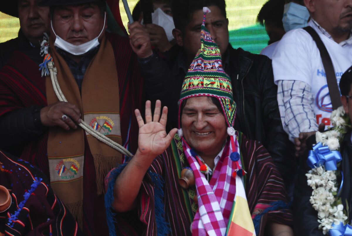 Former president of Bolivia Evo Morales waves to supporters after returning to the country.
