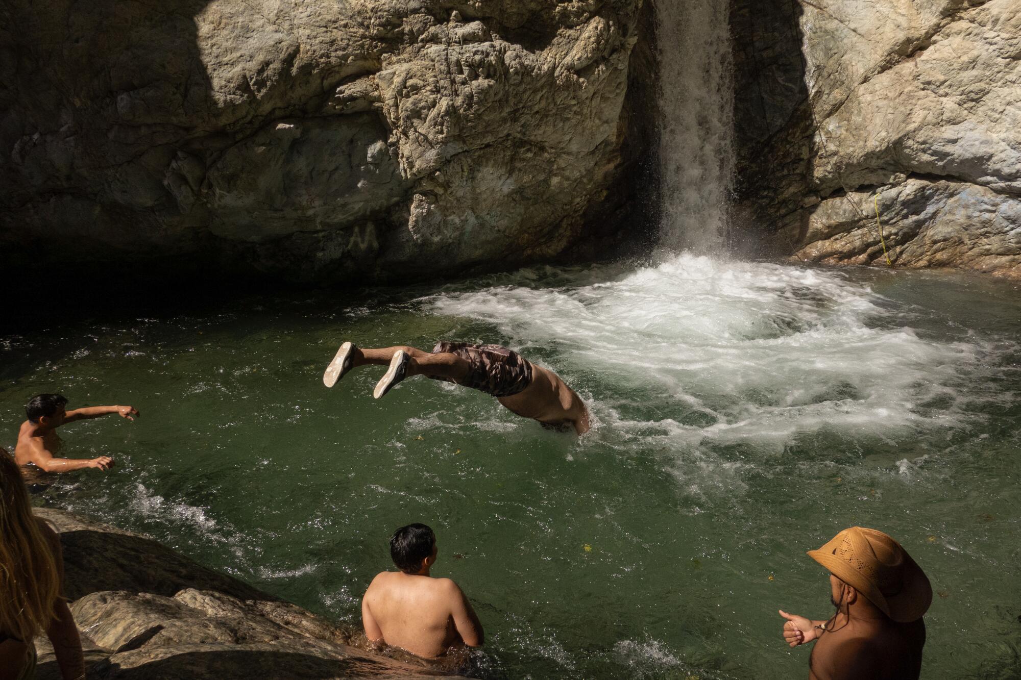 Visitors swim in the pool at Stoddard Canyon Falls and Slide in Mt. Baldy.