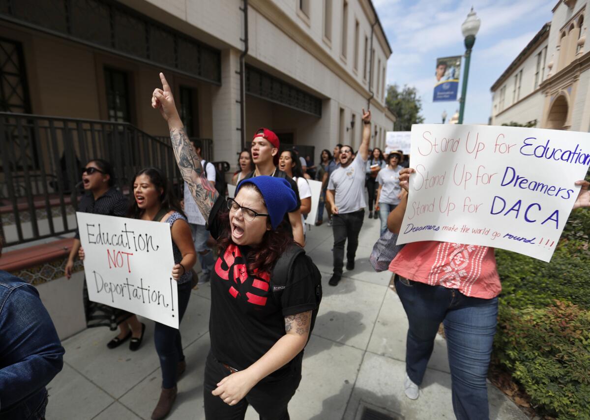 Liz Sanchez, center, a graduate student at Cal State Fullerton, joins students marching around the Fullerton College campus in solidarity with DACA recipients.