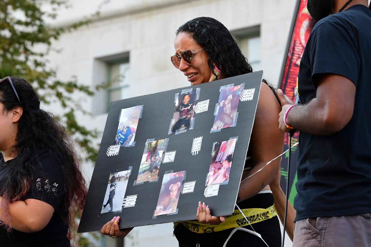 Jonetta Ewing breaks down while addressing the crowd of activists.