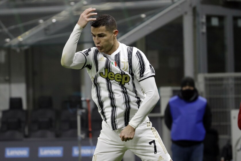 Juventus' Cristiano Ronaldo celebrates his side's first goal after scoring a penalty during the Italian Cup semi-final first leg soccer match between Inter Milan and Juventus at the San Siro stadium, in Milan, Italy, Tuesday, Feb. 2, 2021. (AP Photo/Luca Bruno)