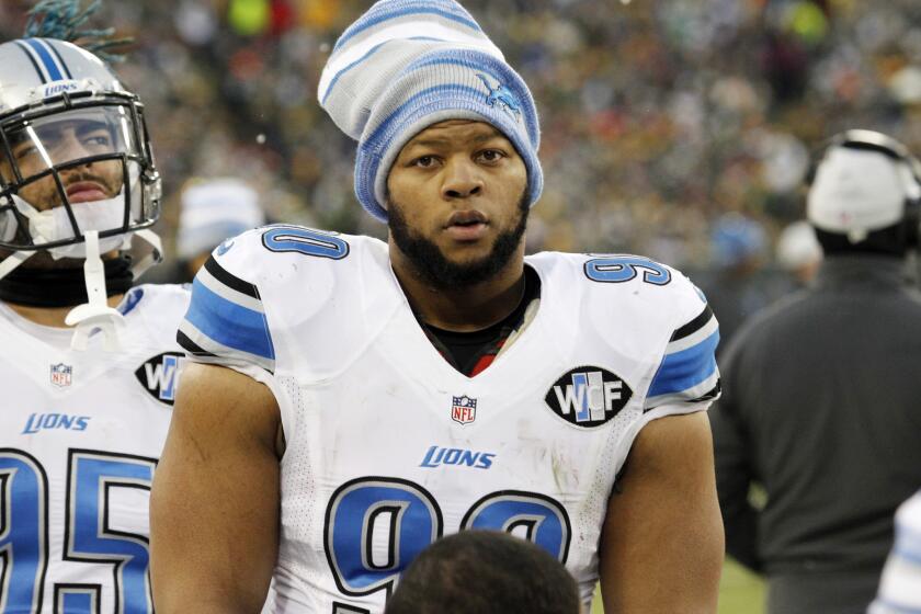 Lions defensive tackle Ndamukong Suh stands on the sideline during a Dec. 28 game against the Packers in Green Bay, Wis.