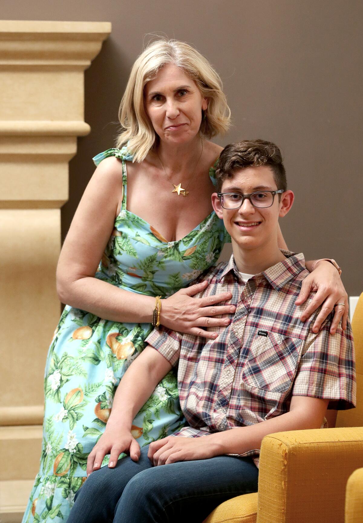 Huntington Beach High School junior Colin Parrott, 16, and his mother, Debbi, pose for a portrait at their home.