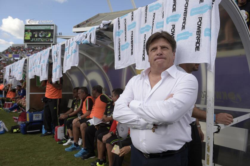 Mexico head coach Miguel Herrera, right, watches from the bench before a friendly soccer match against Costa Rica in Orlando, Fla., Saturday, June 27, 2015. (AP Photo/Phelan M. Ebenhack)