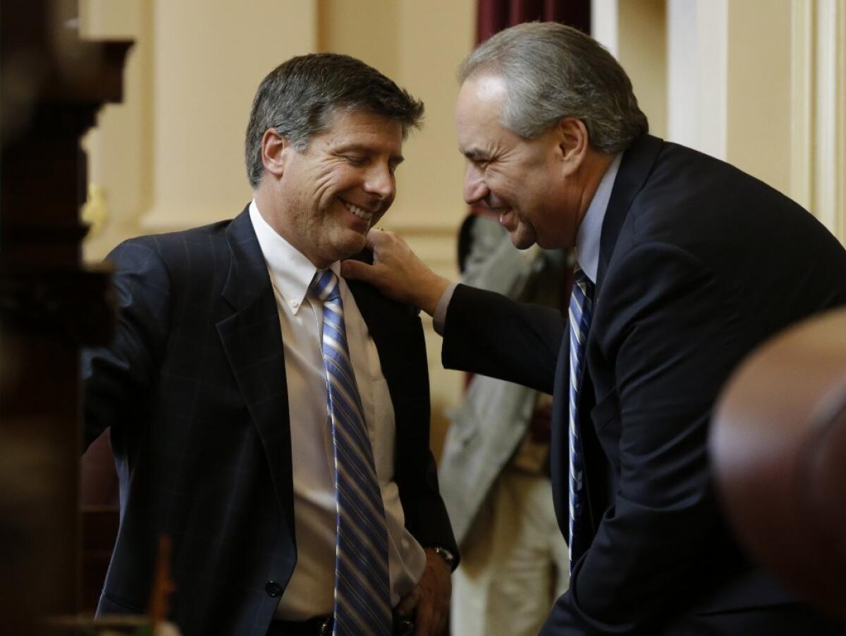 Lt. Gov. Bill Bolling, right, talks with a legislator at the Richmond Capitol earlier this month.