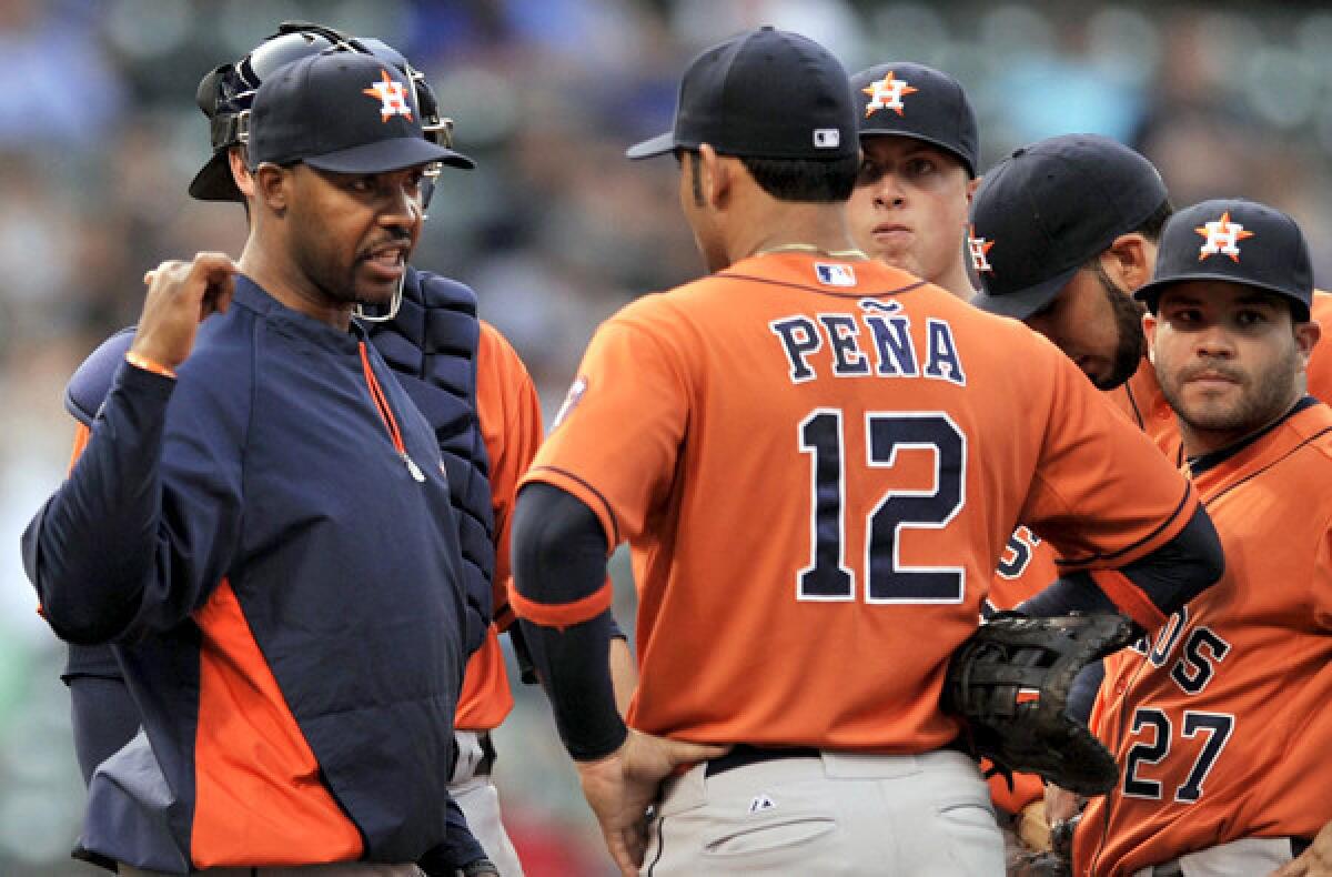Houston Astros Manager Bo Porter discusses strategy with his infielders during a game against the Cubs last week in Chicago.