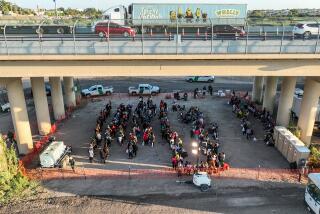 Eagle Pass, Texas, Saturday, September 23, 2023 - People who crossed the US/Mexico border are held at a border patrol processing center located below the Eagle Pass International Bridge. (Robert Gauthier/Los Angeles Times)