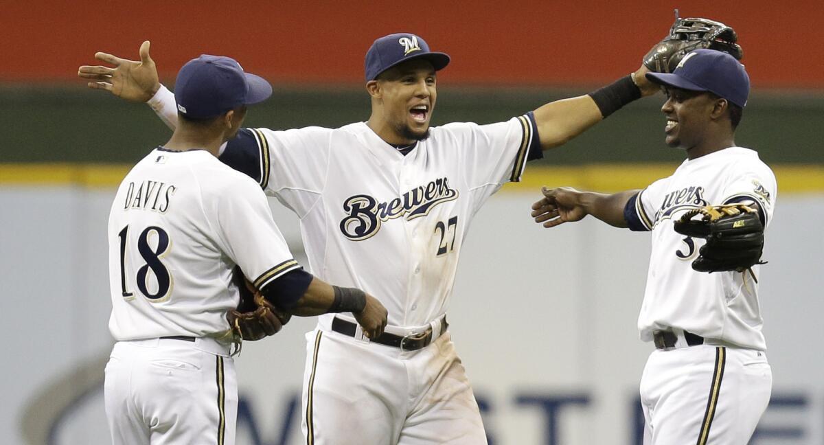 Milwaukee Brewers teammates (from left to right) Khris Davis, Carlos Gomez and Elian Herrera celebrate a 5-3 win over the Chicago Cubs on Saturday.