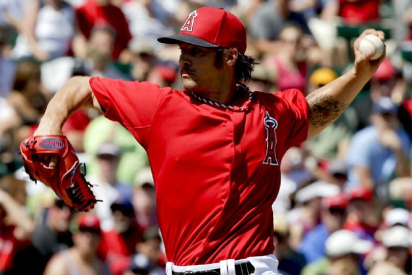 Angels starting pitcher C.J. Wilson throws against the San Diego Padres.