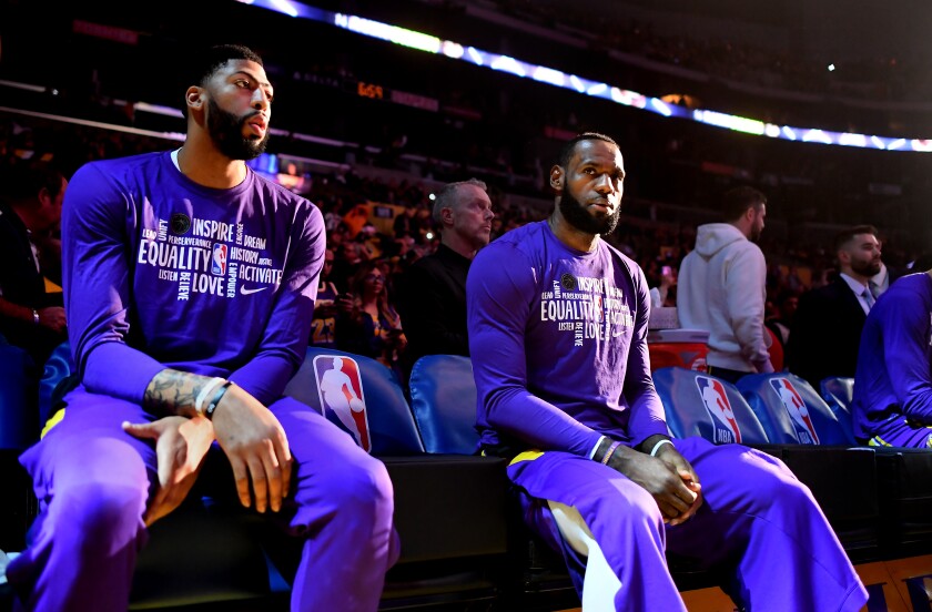 Lakers' Anthony Davis, left, and LeBron James wait to be introduced before a game against the Spurs at the Staples Center on Feb. 4.