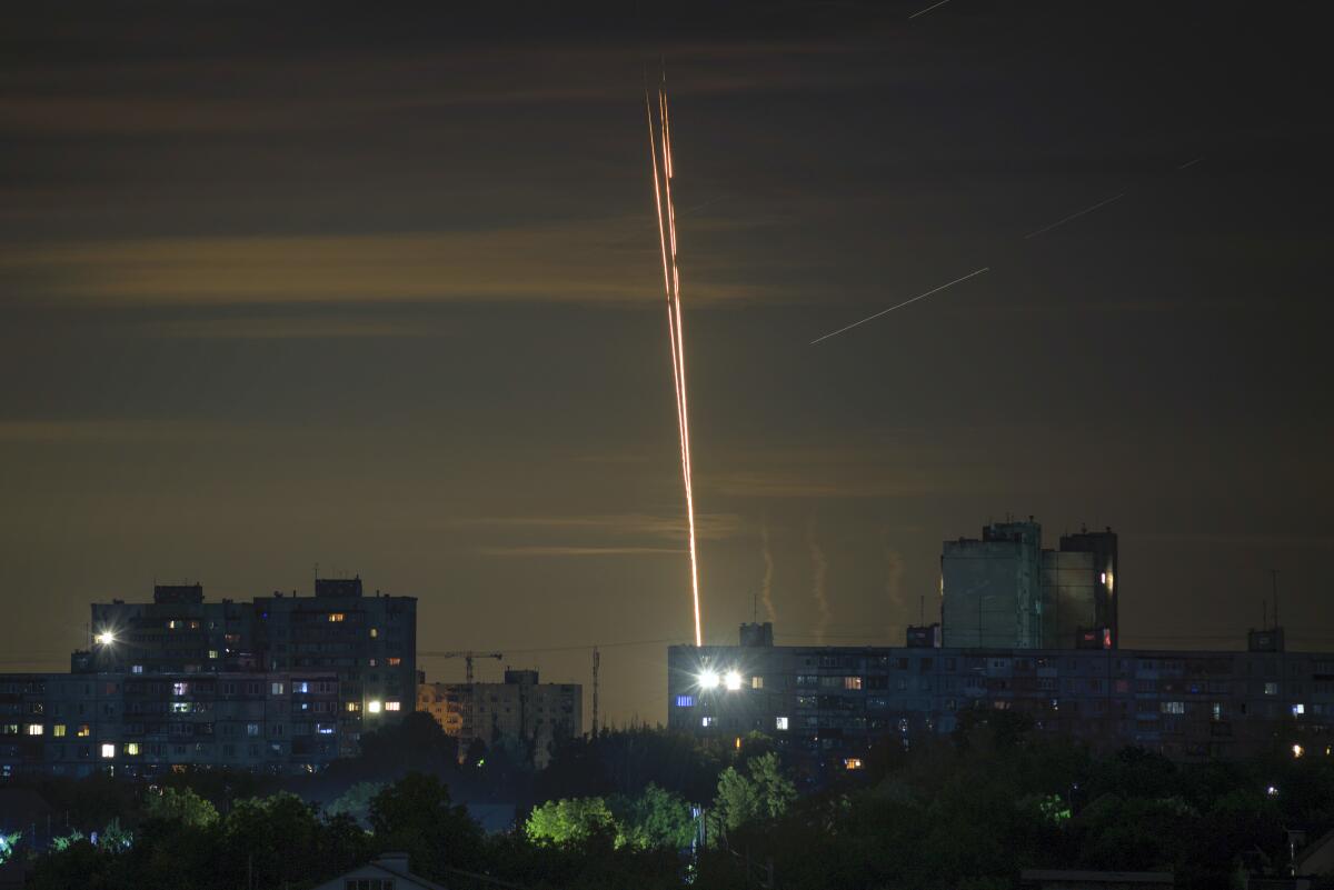 A rocket is launched into a night sky.