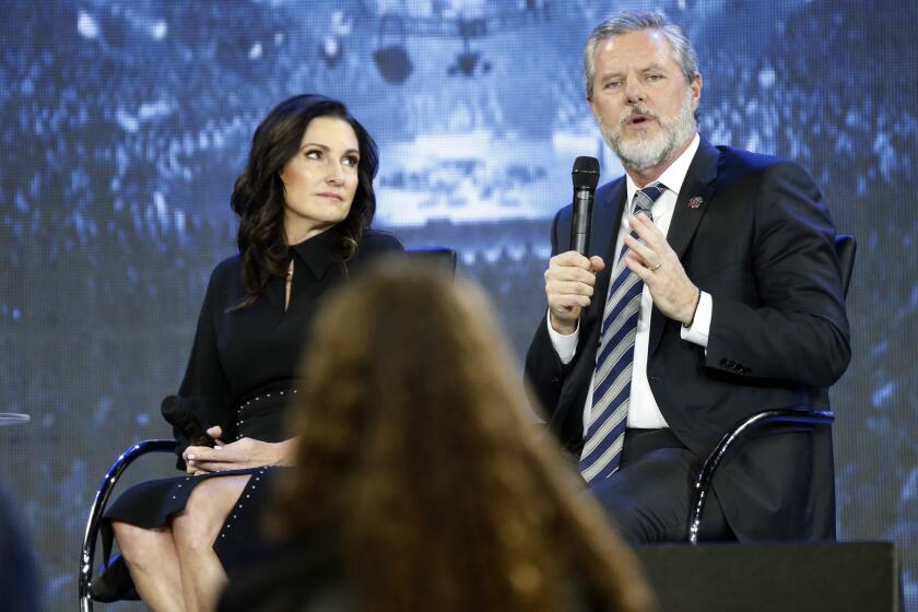 FILE - In this Wednesday, Nov. 28, 2018 file photo, Jerry Falwell Jr., right, answers a student's question, accompanied by his wife, Becki, during a town hall meeting on the opioid crisis at a convocation at Liberty University in Lynchburg, Va. On Aug. 7, 2020, Falwell stepped down, at least temporarily, from his role as the president of the school. (AP Photo/Steve Helber)