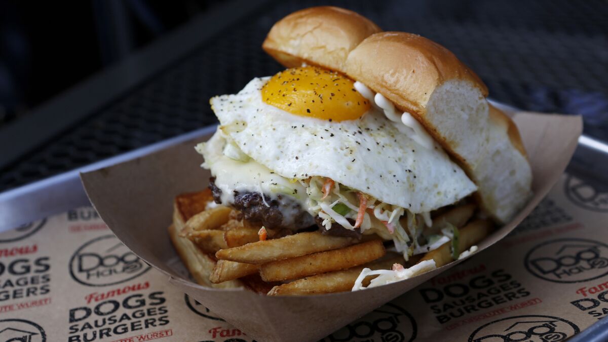 The "Freiburger" with white American cheese, fried egg, slaw, fries and mayo, at Dog Haus in Pasadena.