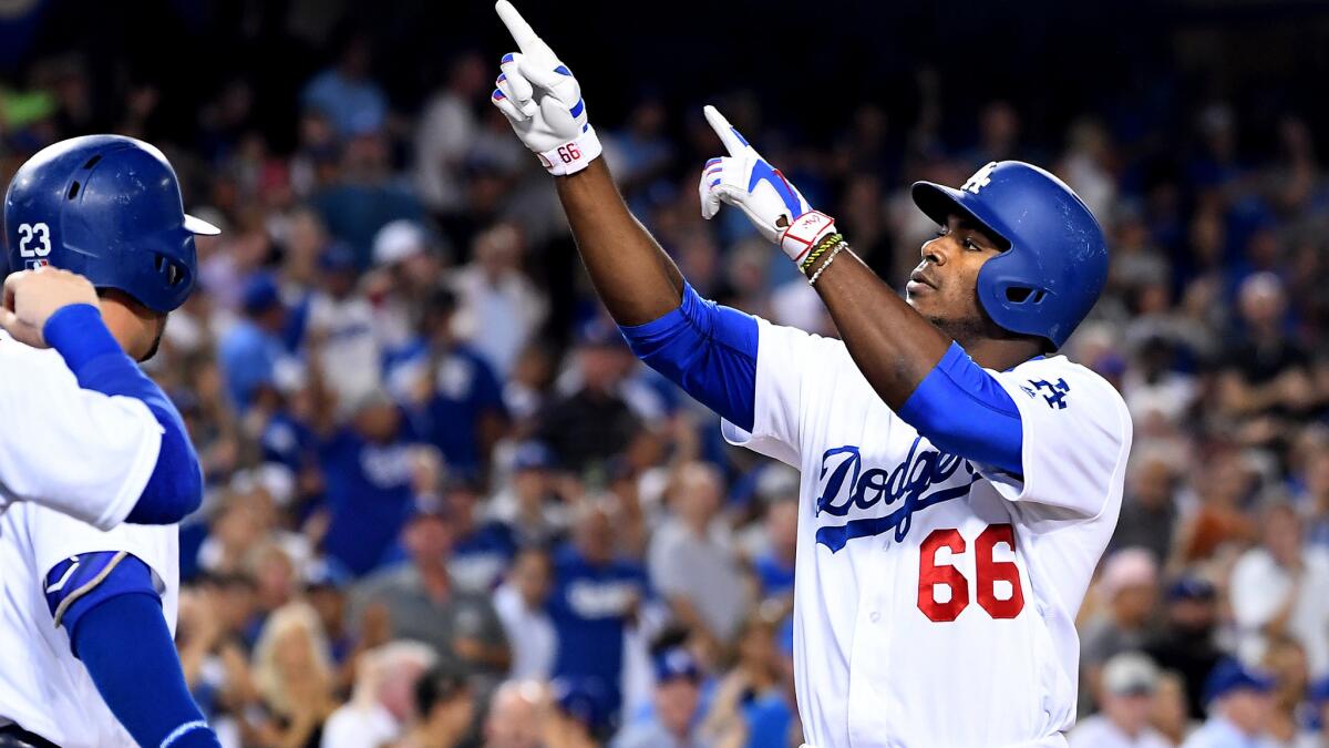 Dodgers right fielder Yasiel Puig celebrates after hitting a three-run home run against the Giants in the first inning Wednesday night.