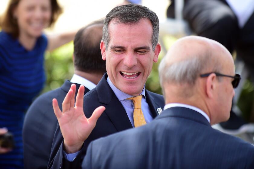 Mayor Eric Garcetti takes part in a Sept. 1 news conference in Santa Monica after the Los Angeles City Council voted to go forward with a bid to host the 2024 Olympic Games.