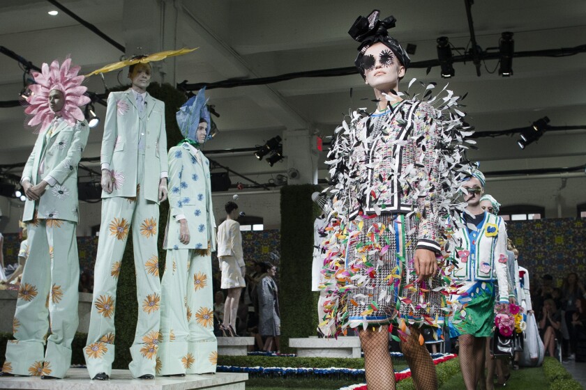 Models walk through the garden-themed runway at the Thom Browne show during New York Fashion Week.