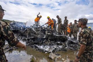 Nepal army personnel sort through the debris after a domestic plane belonging to Saurya Airlines crashed just after taking off at Tribhuvan International Airport in Kathmandu, Nepal, Wednesday, July 24, 2024. (AP Photo/Prabin Ranabhat)