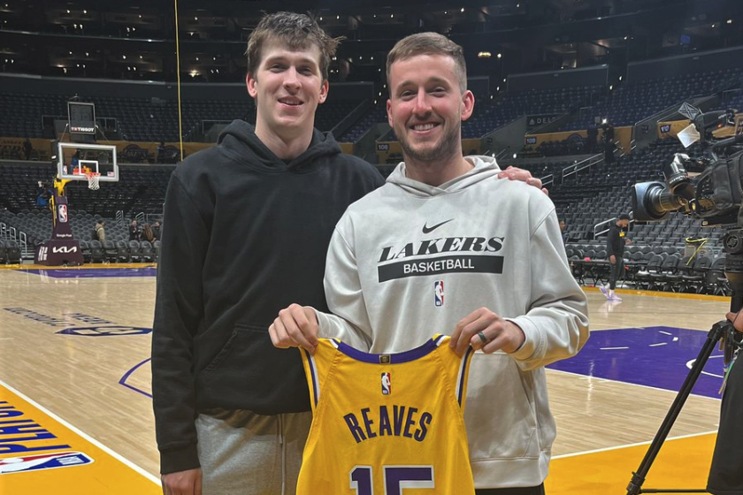 Lakers starter Austin Reaves, left, poses for a photo with his brother Spencer, who is holding Austin's jersey.