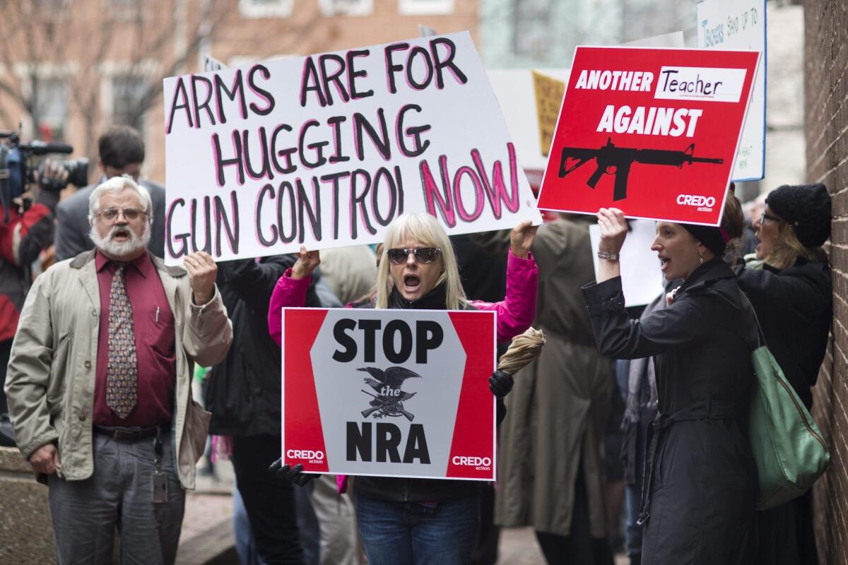 In the wake of the Sandy Hook school shooting massacre, supporters of the progressive gun-control group Credo march to a National Rifle Association (NRA) office on Capitol Hill in Washington, D.C.