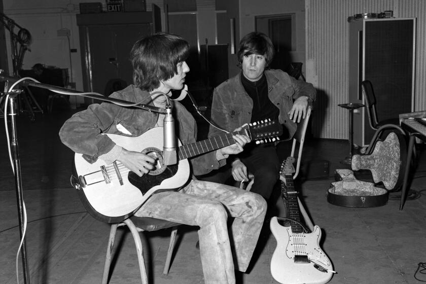 George Harrison plays John Lennon's Framus 12-string Hootenanny acoustic guitar.