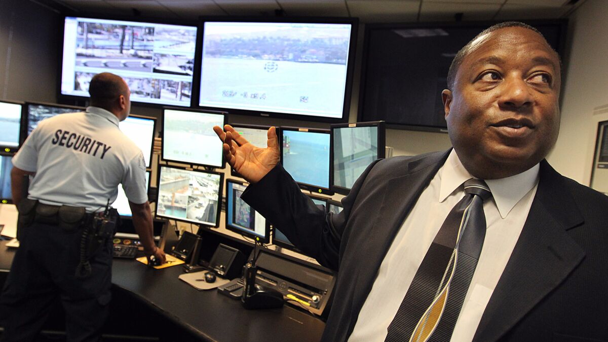 Former Port of Los Angeles Police Chief Ronald J. Boyd, right, visits the port's threat detection center in 2011. Boyd was sentenced to two years in prison Tuesday after pleading guilty to federal tax evasion charges.