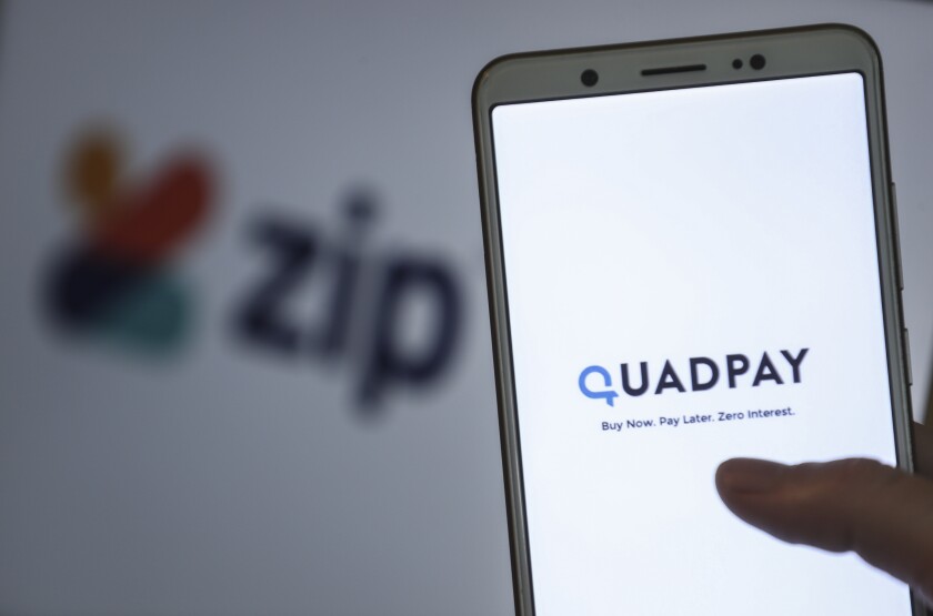 The words Quadpay: Buy Now. Pay Later. Zero Interest. appear on a smartphone screen