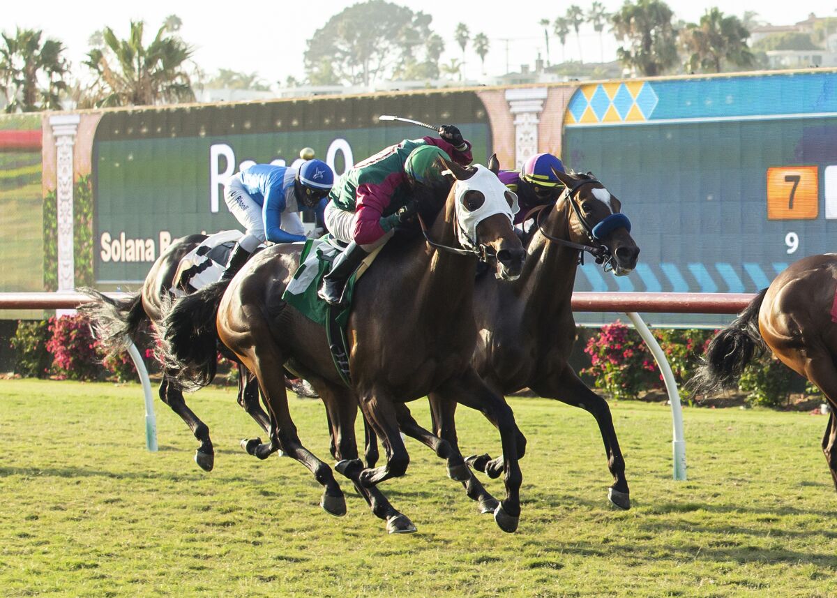 Pulpit Rider and jockey Juan Hernandez, outside, overpower win the $125,000 Solana Beach Stakes.