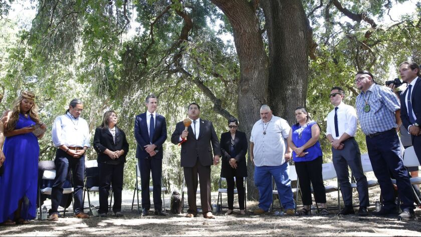 Assemblyman James Ramos (D-Highlands) of the San Manuel Band of Mission Indians, fifth from left, opens a meeting with tribal leaders from around the state, attended by Gov. Gavin Newsom, fourth from left, at the future site of the California Indian Heritage Center.