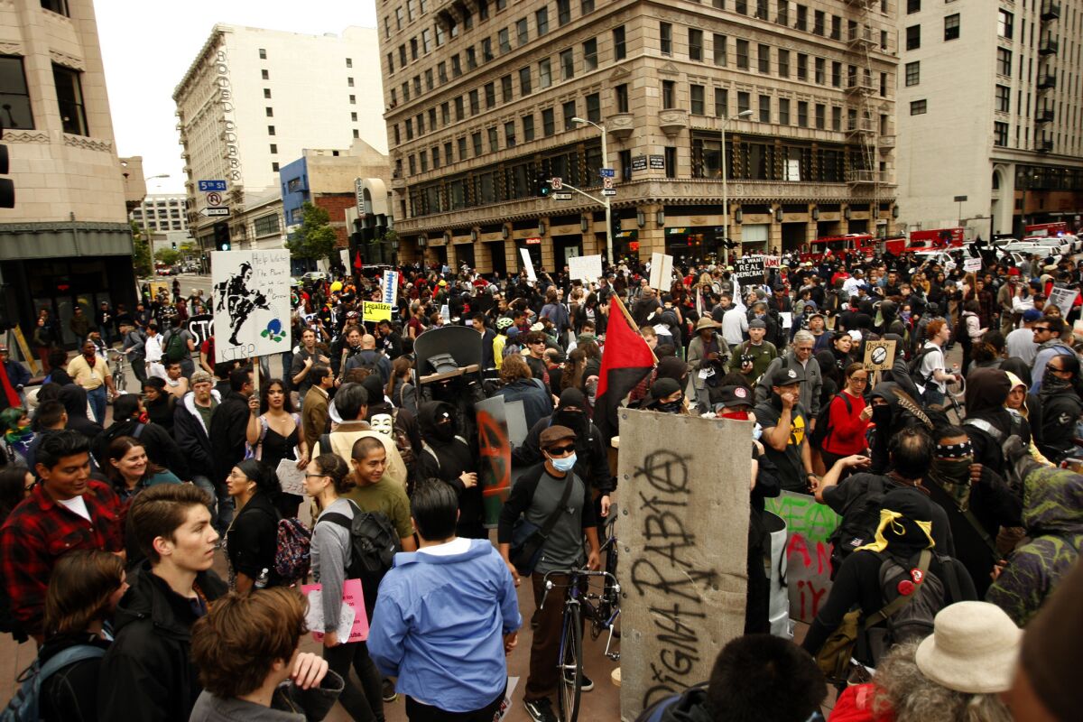 Hundreds of members with the Occupy LA movement crowd the intersection at 5th and Hill streets as part of May Day activities in downtown Los Angeles in 2012.