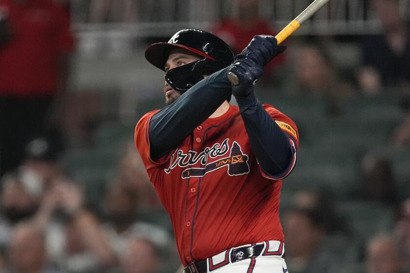 Atlanta Braves' Travis d'Arnaud (16) hits a grand slam in the sixth inning of a baseball game against the Texas Rangers Friday, April 19, 2024, in Atlanta.The home run was d'Arnaud's third of the game. (AP Photo/John Bazemore)