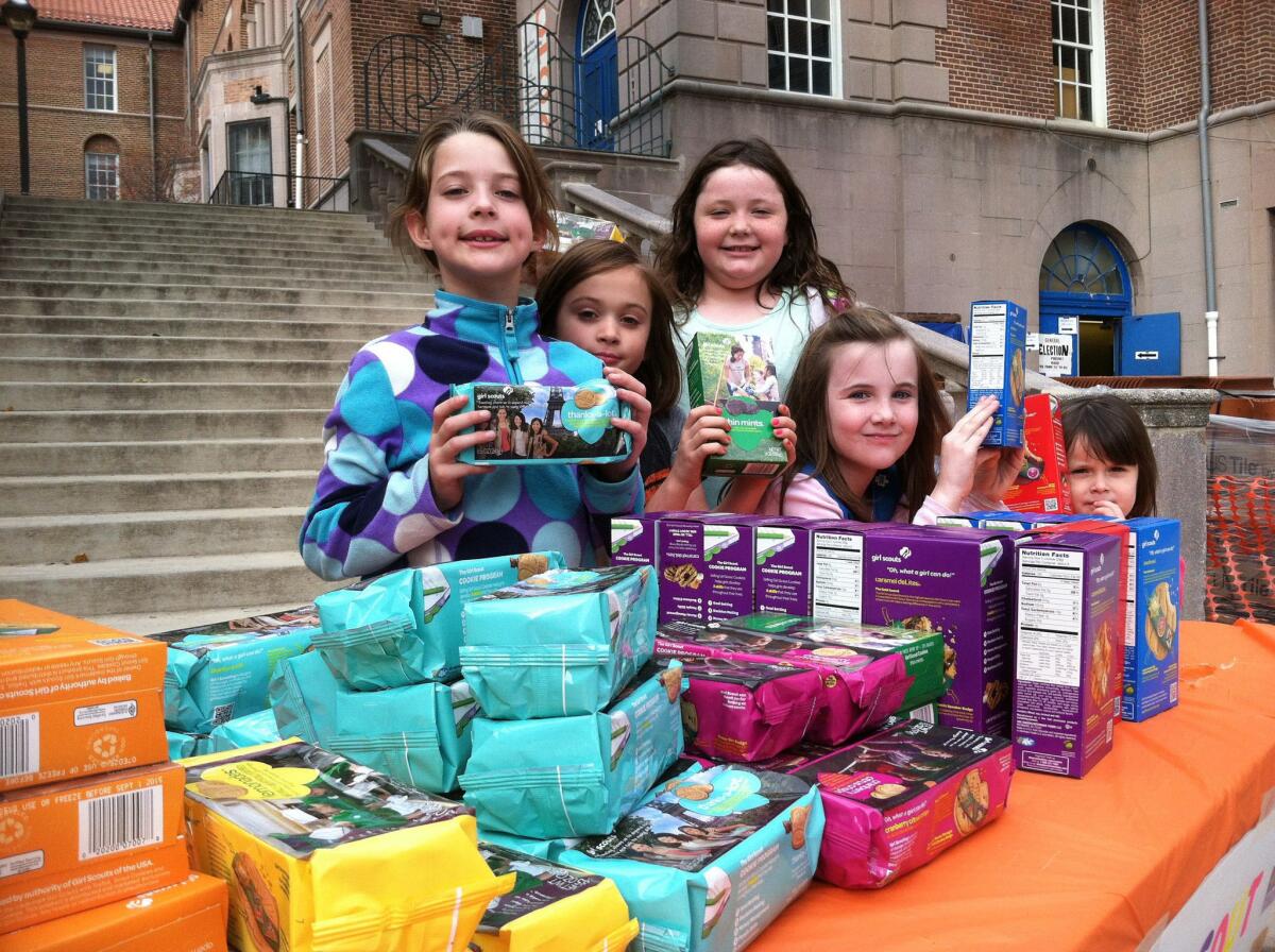 Girl Scouts sell boxes of cookies. The organization announced the release of three new cookie flavors this year, including two gluten-free varieties.