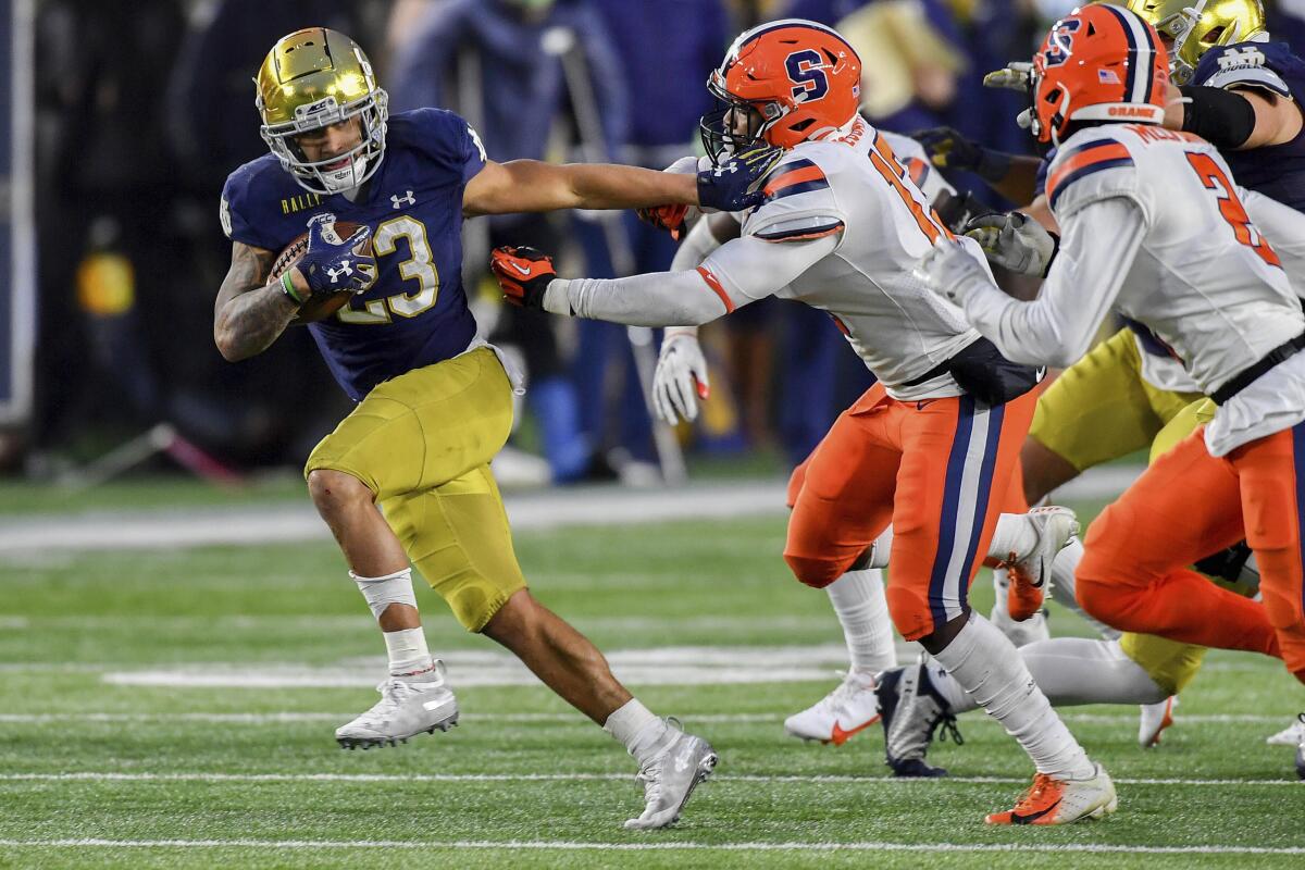 Notre Dame running back Kyren Williams stiff-arms Syracuse linebacker Mikel Jones during the first quarter Saturday.