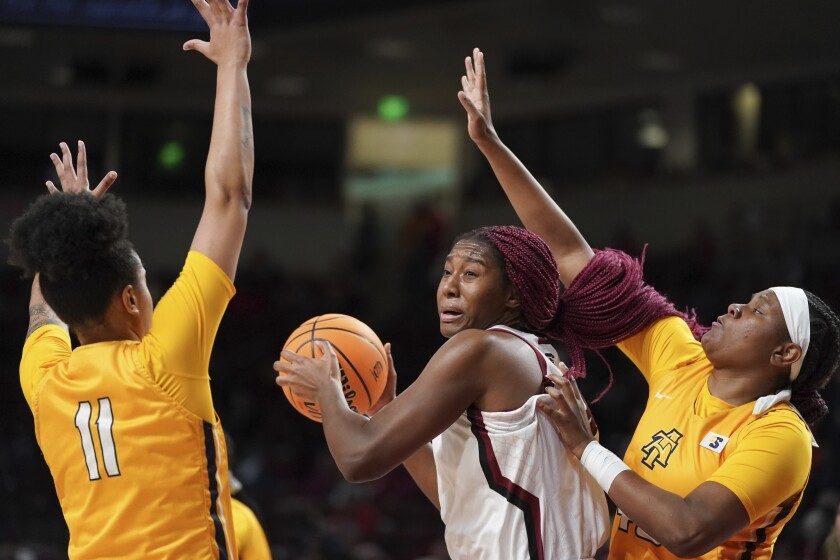 South Carolina forward Aliyah Boston (4) is defended by North Carolina A&T center Jazmin Harris, right, and Kiana Adderton (11) during the first half of an NCAA college basketball game Monday, Nov. 29, 2021, in Columbia, S.C. (AP Photo/Sean Rayford)