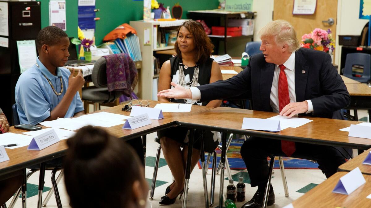 Donald Trump reaches to shake hands with a student during a meeting with students and educators at Cleveland Arts and Social Sciences Academy in Cleveland on Sept. 8.