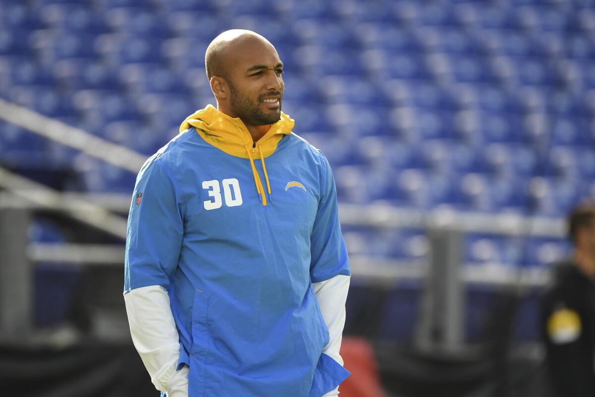 Chargers running back Austin Ekeler looks on before a game.