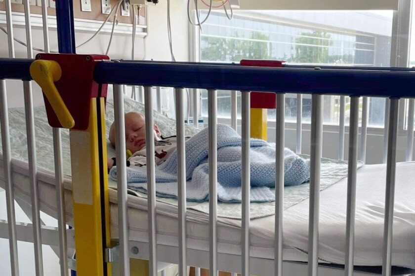 A baby in a hospital bed.