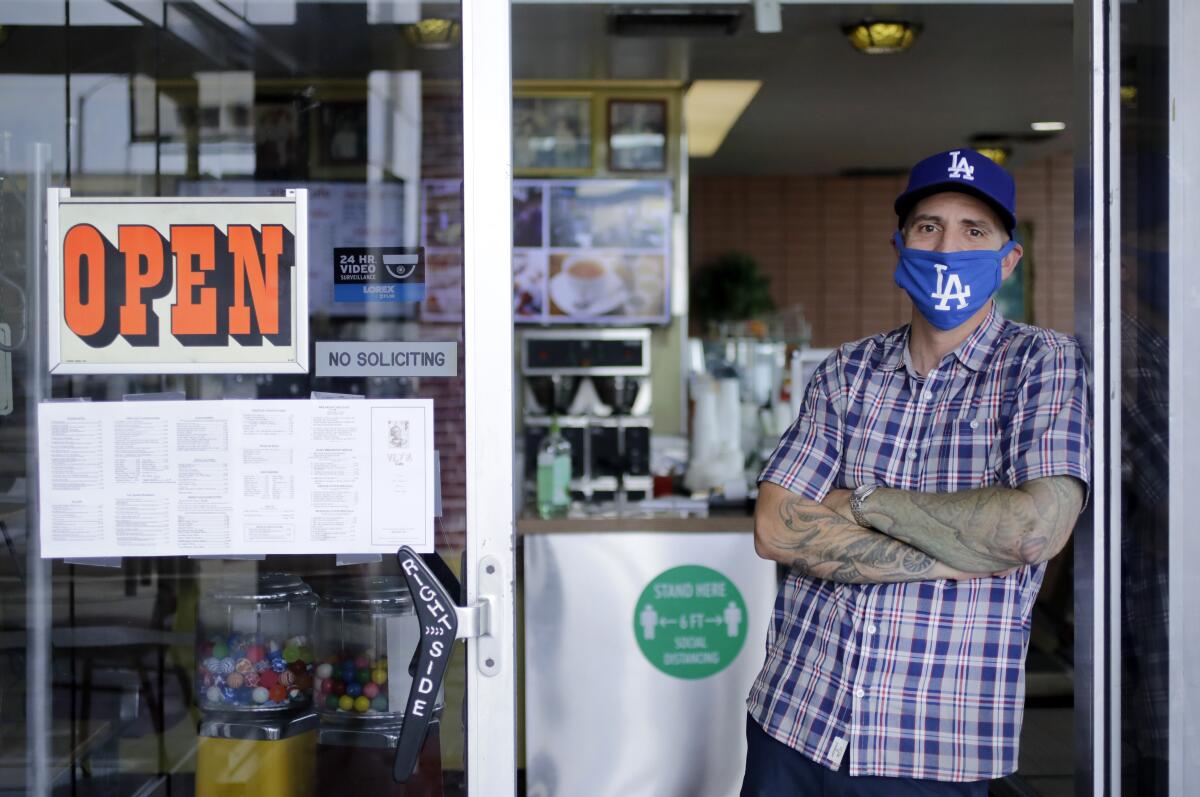 Ryan Hagen, who started a GoFundMe page for the owners, Paul and Lucy Ma, stands in the doorway at VIP's Cafe.