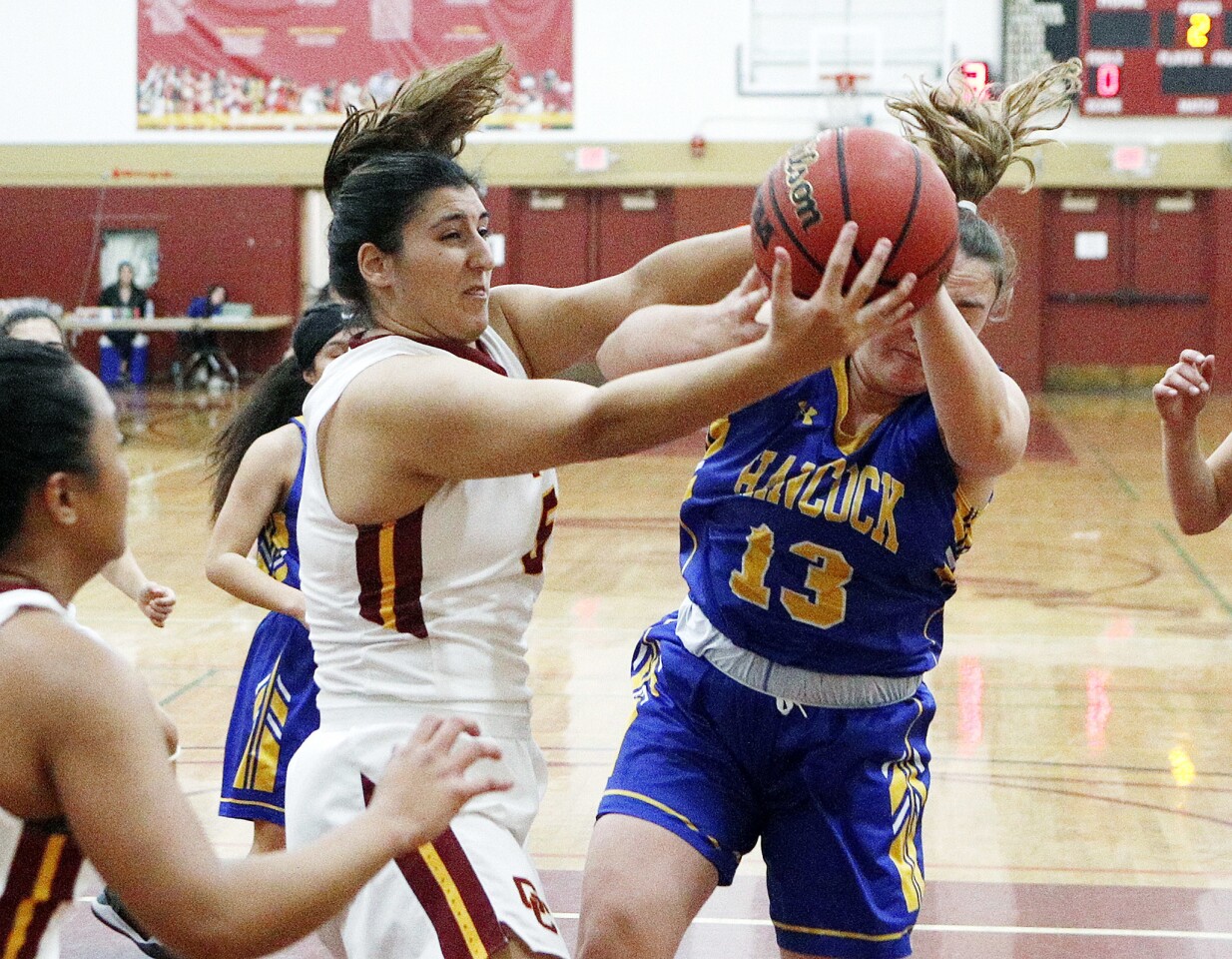 Glendale College's Sylvia Vartazarian and Allan Hancock College's Willow Bailey battle for a rebound in the first half of a Glendale College Vaqueros holiday tournament women's basketball game at Glendale Community College on Wednesday, December 19, 2018.
