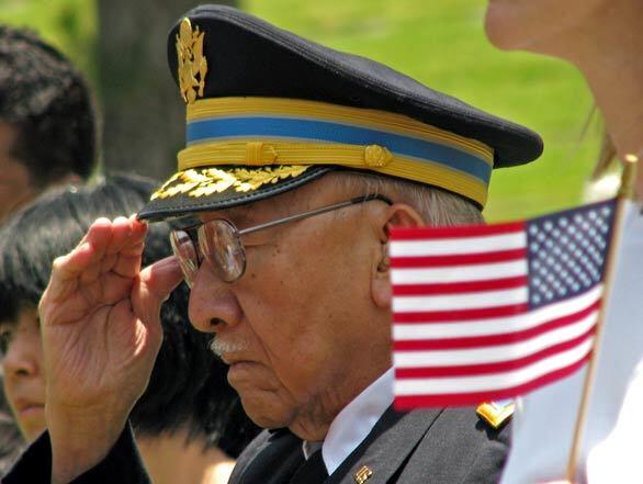 Retired Army Col. Hayward Fong, 84, salutes the flag during a Memorial Day celebration at Forest Lawn Memorial Park in Glendale.
