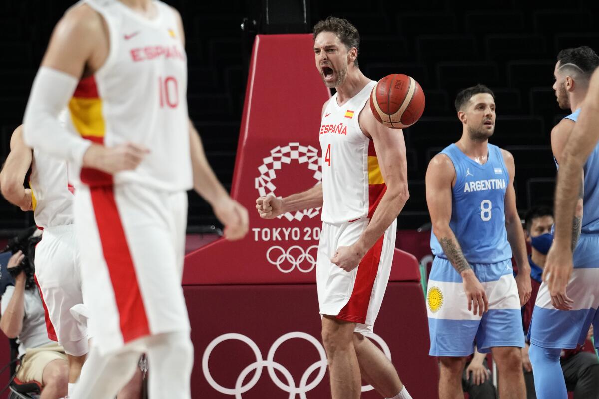 Paul Gasol pumps a fist and shouts during a basketball game at the Tokyo Olympics.