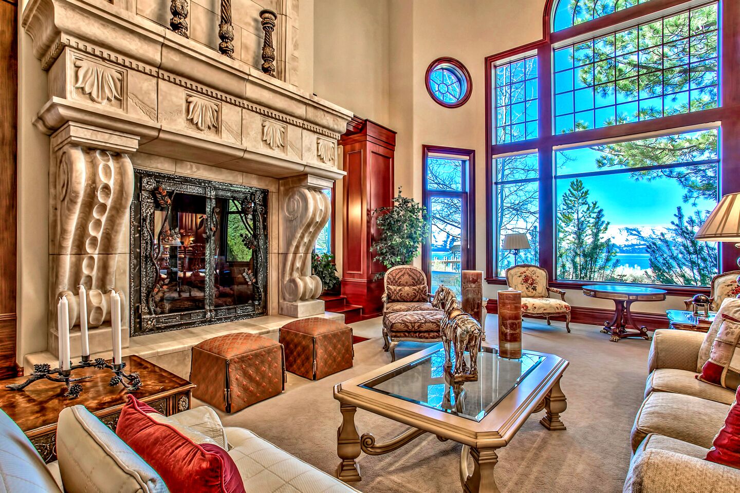 The interior of the home features a large, ornate fireplace and windows with views of Lake Tahoe