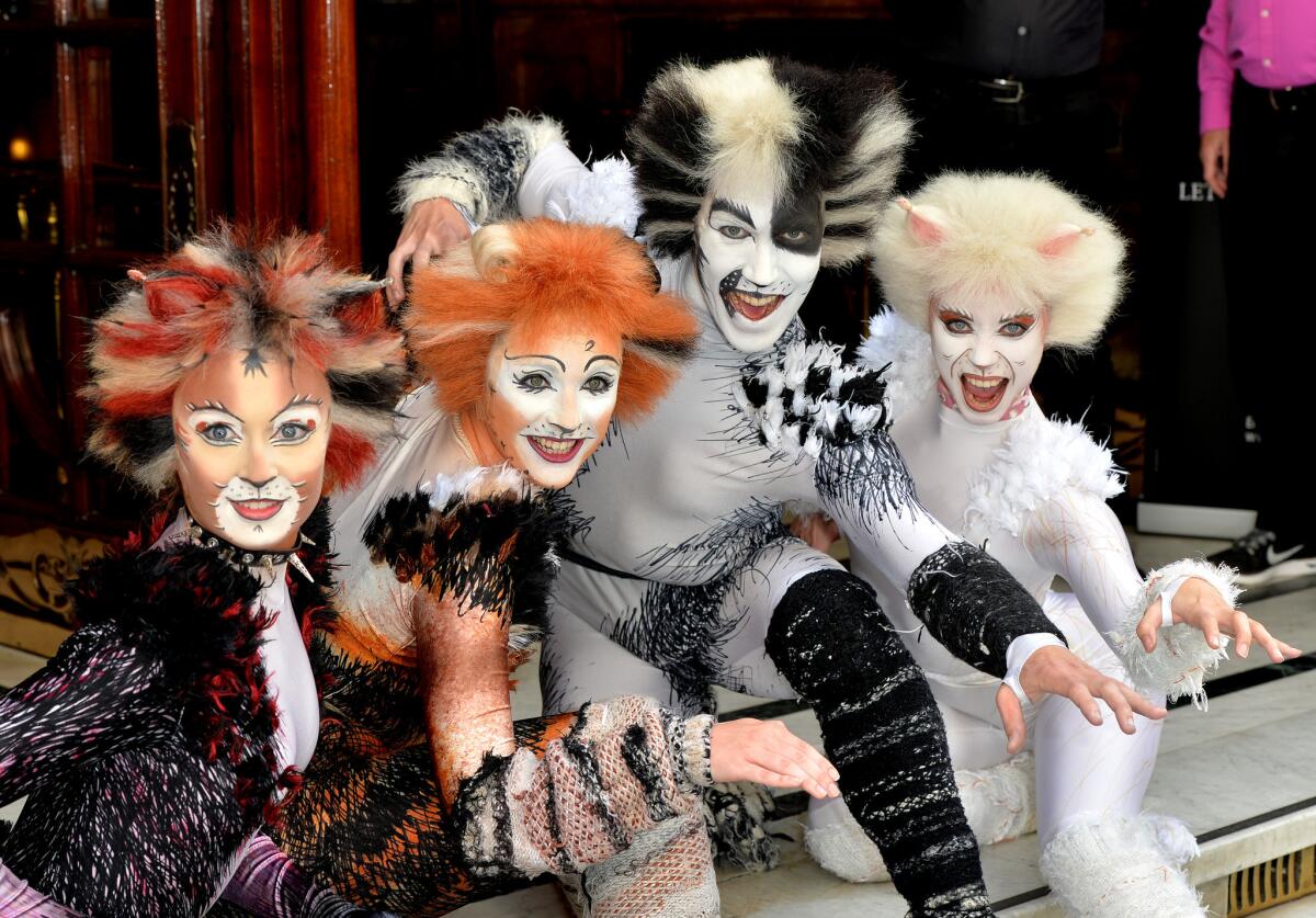 Members of the new London cast of "Cats" strike feline poses.