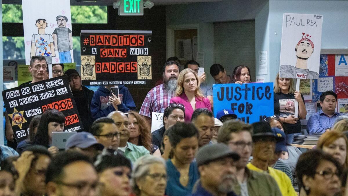 Residents speak out about the East Los Angeles station of the Sheriff's Department at a meeting Thursday, the same day news broke of an FBI probe into the Banditos, an inked deputy gang at the station.