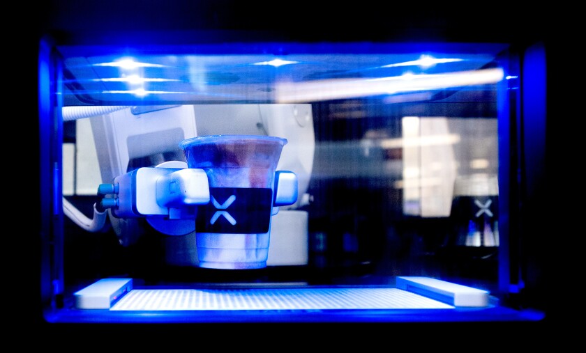 A Cafe X robot dispenses a cappuccino at San Francisco International Airport.