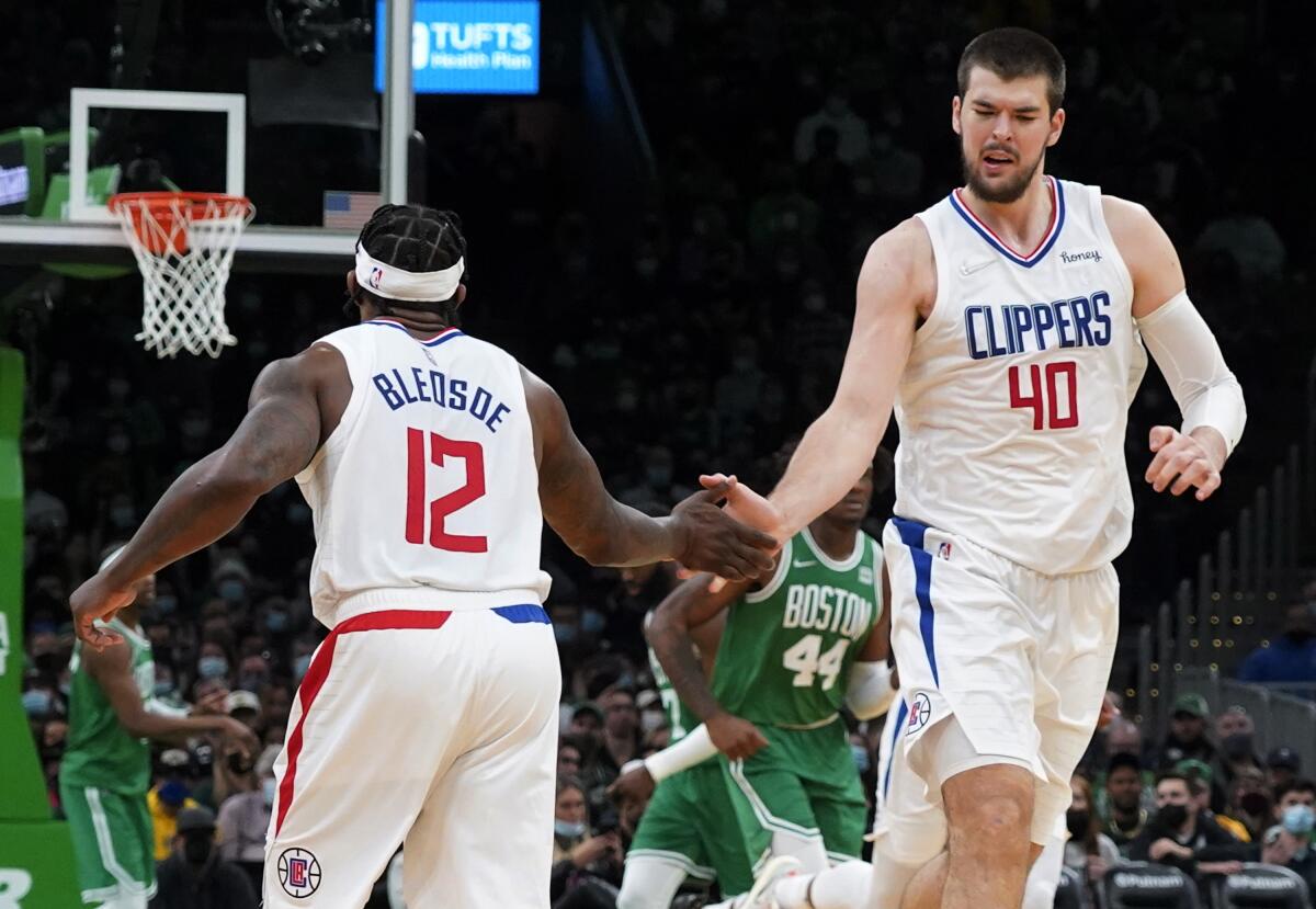 Clippers center Ivica Zubac and guard Eric Bledsoe celebrate a basket.